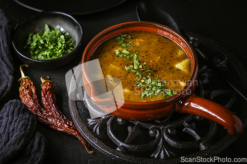 Image of Hungarian hot goulash soup, beef, tomato, pepper, chili, smoked paprika soup. Traditional Hungarian dish.