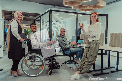 Image of Young group of business people brainstorming together in a startup space, discussing business projects, investments, and solving challenges.