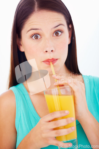 Image of Shock, drinking and portrait of woman with juice for nutrition, wellness and hydration in studio. Surprise, comic and face of person with fruit blend for vitamins, detox and diet on white background