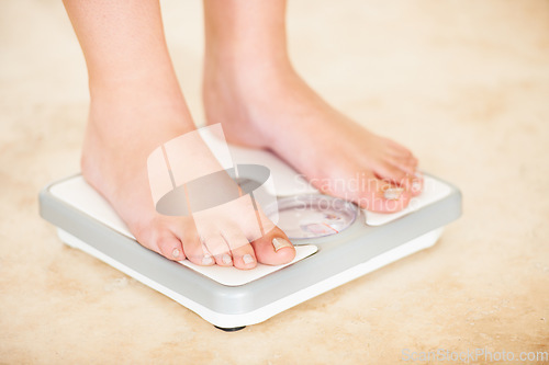 Image of Woman, weight loss and feet on scale for measurement, goal and control diet for health and wellness. Fitness, scales and closeup measuring, check and weighing body, mass and electronic device or tech