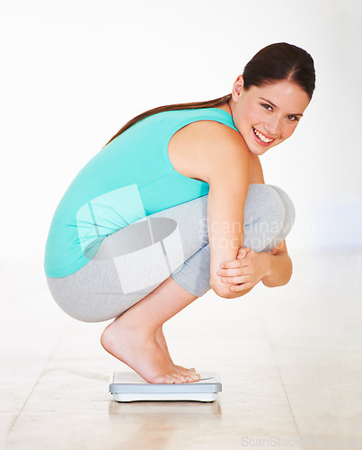 Image of Scale, check and woman lose weight in portrait happiness, diet and measuring body, mass and health. Weighing, bmi and person excited with a smile for numbers, progress and dieting results in home