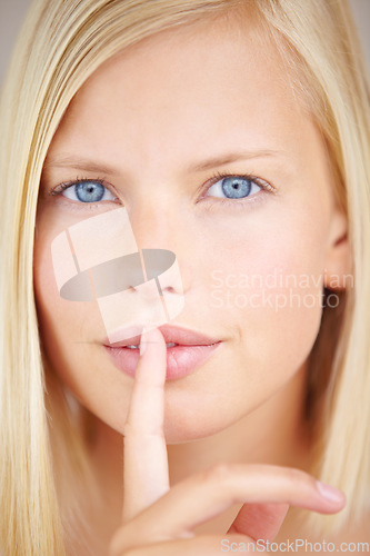 Image of Woman, quiet and finger on lips in portrait with sign, secret deal or story for promotion by background. Girl, hand and mouth for silence icon, whisper or gossip for voice, news or privacy in closeup