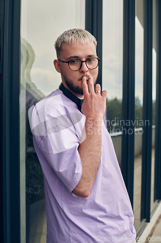 Image of In front of a modern glass building, a young, blond influencer strikes a confident pose, epitomizing urban glamour and style in the heart of the city