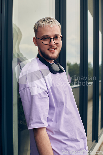 Image of In front of a modern glass building, a young, blond influencer strikes a confident pose, epitomizing urban glamour and style in the heart of the city