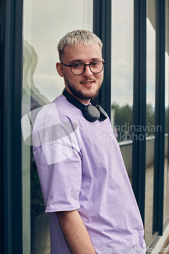 Image of In front of a modern glass building, a young, blond influencer strikes a confident pose, epitomizing urban glamour and style in the heart of the city