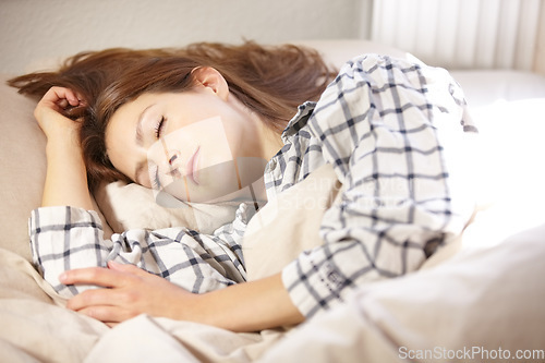 Image of Woman, sleeping and tired for fatigue in bedroom with nap in morning for insomnia. Person, girl or lying down for rest, peace or calm for blanket in comfort in home for health, wellness or exhaustion