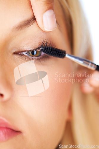 Image of Makeup, mascara and woman with hands in studio for volume, care or professional application closeup. Eyelash extension, beauty and eyes of model with beautician for glam, texture or transformation