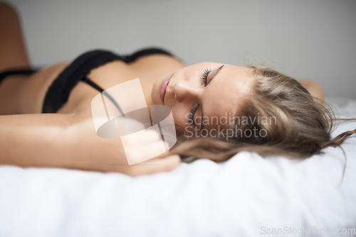 Image of Lingerie, woman and bed with sleeping, rest and relax in a bedroom with underwear and calm. Sexy, fashion and confidence with nap at home on a blanket and sheets lying down with peace and bra