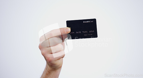 Image of Hand, payment and closeup of credit card in a studio for online shopping, paying bills or debt. Ecommerce, money and zoom of person with bank account for buying products isolated by white background.