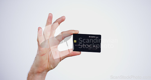 Image of Hand, money and closeup of credit card in a studio for online shopping, paying bills or debt. Ecommerce, payment and zoom of person with bank account for buying products isolated by white background.