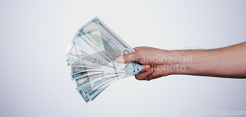 Image of Hand, payment and closeup of cash in a studio for retail shopping, paying bills or debt. Mockup, paper money and zoom of person with dollar bank notes for buying products isolated by white background