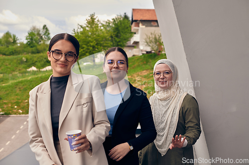Image of A group of professional businesswomen taking a break, sipping coffee and engaging in discussions, fostering a sense of empowerment and collaboration in the modern workplace.