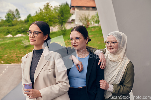 Image of A group of professional businesswomen taking a break, sipping coffee and engaging in discussions, fostering a sense of empowerment and collaboration in the modern workplace.