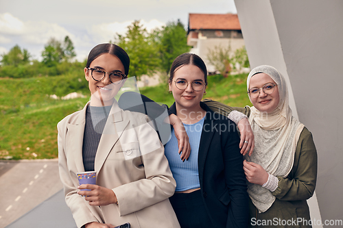 Image of A group of professional businesswomen taking a break, sipping coffee and engaging in discussions, fostering a sense of empowerment and collaboration in the modern workplace.