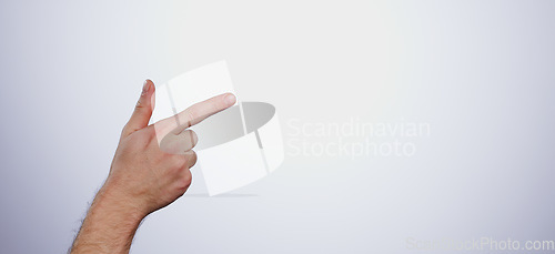 Image of Hand, pointing and person in studio with mockup space for advertising, promotion or marketing. Finger, closeup and man model with show or presentation gesture for empty mock up by white background.