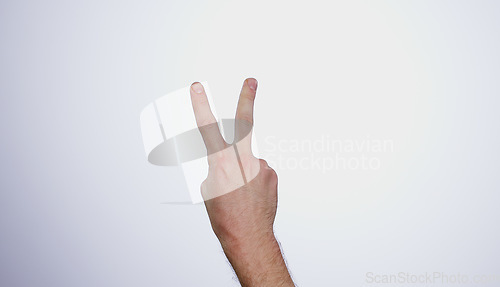 Image of Hand, counting two and person in studio with mockup space for advertising, peace emoji, promotion or marketing. Fingers, closeup and man model with mathematics numbers gesture for empty mock up by wh