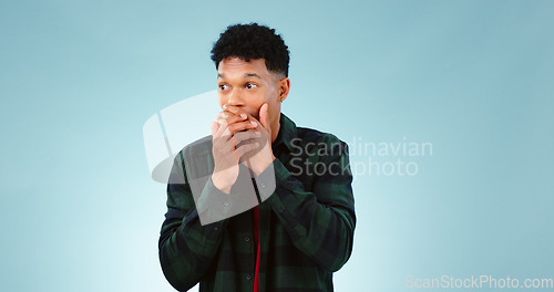 Image of Surprise, wow and hands on face of man in studio with shocking, news or info on blue background. Omg, gossip and male model with emoji reaction or drama, announcement or secret, giveaway or promotion