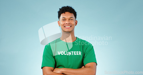 Image of Happy man, volunteer and smile with portrait in studio for eco friendly mock up on blue background in Cape Town. Young person, model and excited for choice, prevention and climate change for future