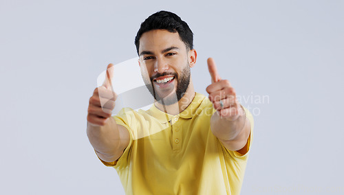 Image of Thumbs up, portrait and man in studio for winner, achievement and celebrate deal on white background. Happy indian model, emoji and like sign for yes feedback, promotion and thank you for excellence