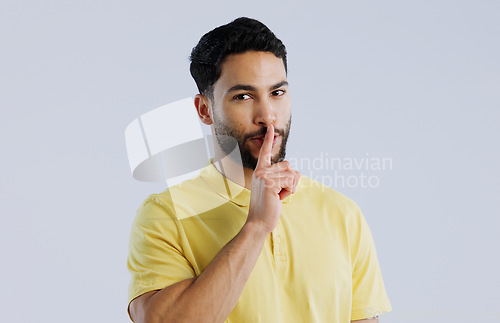 Image of Secret, man and portrait in studio for sign of privacy, surprise sales and confidential deal on white background. Indian model with finger on lips for quiet, gossip news and mystery emoji to whisper