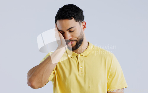 Image of Stress, burnout and a young asian man in studio isolated on a white background for mental health. Anxiety, headache and the hands of a sad person on his face in frustration for worry or a mistake