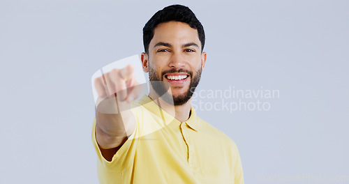 Image of Man, portrait and pointing to you in studio for choice, decision and vote for winner, volunteer or recruitment on white background. Happy indian model show finger for support, emoji and invitation