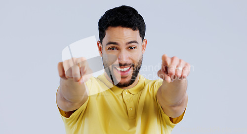 Image of Happy man, portrait and pointing to you for choice, decision and vote for winner, volunteer or recruitment in studio on white background. Indian model, smile and finger for support, emoji and join us