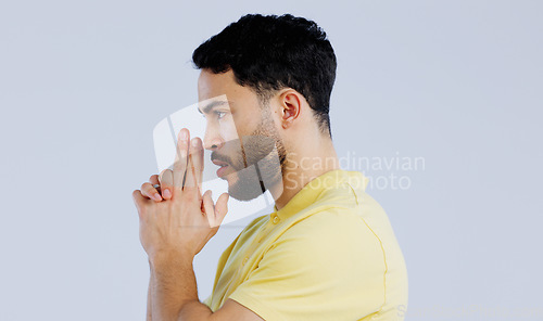 Image of Finger gun, pointing and profile of man in studio with aim for target, shooting and spy on blue background. Secret agent, mockup space and face of person with hand gesture for pistol or weapon