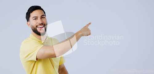 Image of Happy, man and portrait of pointing to space in studio for advertising information, deal and choice on white background. Indian model, presentation and mockup for feedback, promotion and announcement