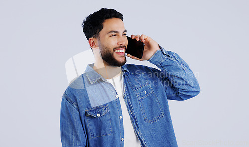 Image of Man, phone call and communication in studio for contact, networking and funny conversation on white background. Happy young indian model, mobile discussion and laugh for chat, talking and connection