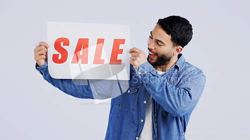 Image of Man, sale and excited with board in studio mockup, shopping discount and advertising retail announcement. Young person, arab and marketing for deal promotion with product launch by white background