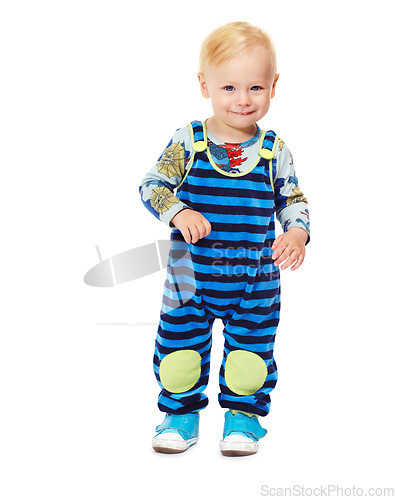 Image of Toddler, boy and baby in studio with fashion, style and grow with curiosity, happiness and shy for kindergarten. Child, smile and standing in white background in jumpsuit, outfit and clothes