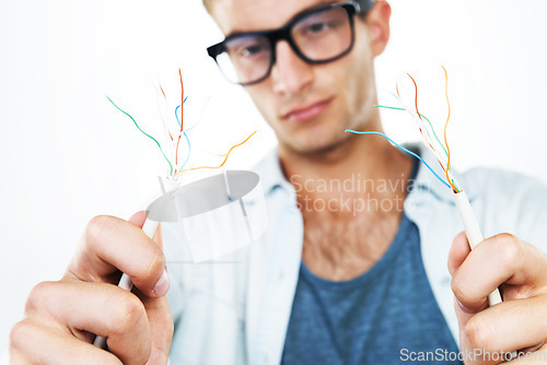 Image of Working, electrician and man with cables, test and and check for power in white background. Studio, technician or electricity, wires and maintenance of connection, technology or hardware closeup