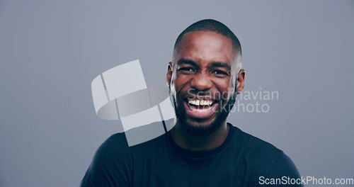 Image of Face, happy or black man laughing at joke or crazy comedy in studio isolated on gray background. Funny, African model or silly male person with freedom, goofy smile or joy to relax alone with humor