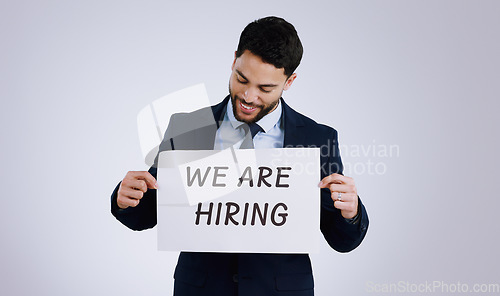 Image of Happy businessman, job and hiring sign for opportunity, advertising or marketing against a gray studio background. Man smile with billboard or poster for recruiting, interview or career position