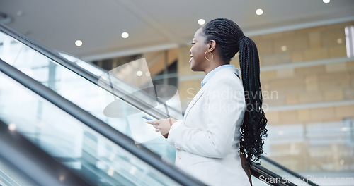 Image of Business, escalator and travel with black woman, smartphone and social media with accountant. African person, employee and broker with a cellphone, airport and happy with connection and digital app