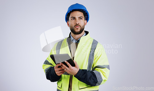 Image of Man, architect and thinking with tablet for construction or planning against a gray studio background. Male person, contractor or engineer in wonder, thought or plan with technology for architecture