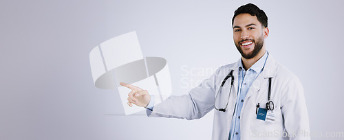 Image of Portrait, smile and doctor pointing at presentation, mockup or space on a white background. Face, happy medical professional advertising and announcement of info, healthcare man and marketing gesture