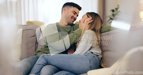 Image of Happy couple, in love and together on sofa in living room for eye contact, trust or bonding. Man, woman and married with embrace for hug in romance, care or comfort in connection on honeymoon in home