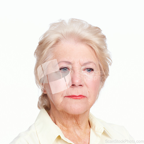 Image of Reliving regrets. Closeup of a despondent senior woman isolated on white background.