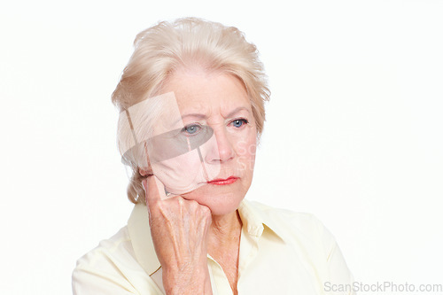 Image of Negative nostalgia. Closeup of a depressed senior woman with her hand to her cheek looking away sadly - Isolated on White.