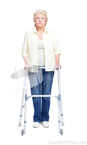 Image of Overcoming disability. Full-length portrait of a serious elderly woman holding her zimmer frame while isolated on white.