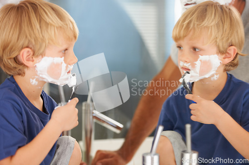 Image of This how my dad does it. A young boy with a face full of shaving cream looking in the mirror.