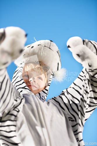 Image of My costume is the best. Little kid wearing a tiger costumer with his arms raised.