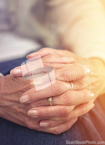 Image of Hands, retirement and closeup with a mature woman indoor thinking about a past memory of nostalgia. Fingers, wrinkles and old age with a senior female pensioner sitting in her home feeling lonely