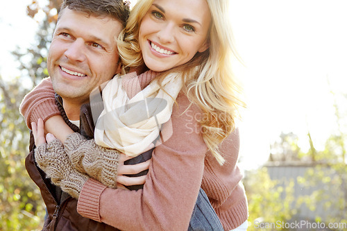 Image of Enjoying the perfect outdoors date. A happy man piggybacking his girlfriend while spending time in the woods.