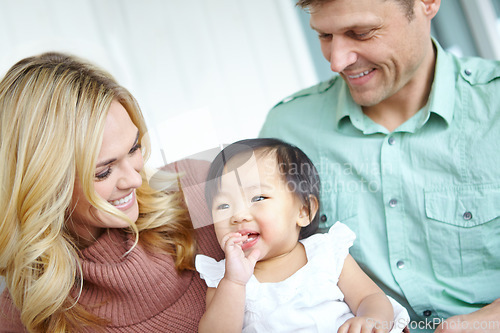 Image of Shes captured their hearts. A happy couple spending time with their beautiful adopted daughter while at home.