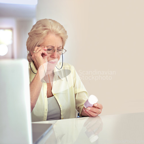 Image of Making sure shes taking the right dose. a senior woman checking her medication at home.