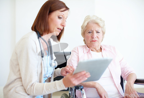 Image of I have some concerns regarding your test results. Mature nurse explains the outcome of her elderly patients medical tests.