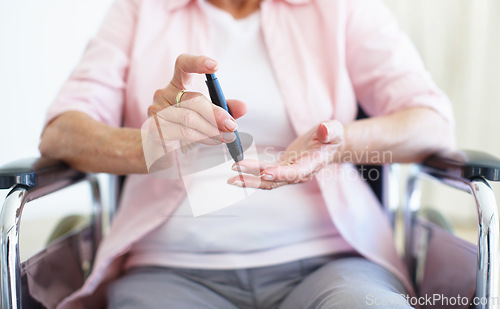 Image of A pin-prick to the finger - DiabetesSenior Health. Cropped closeup of a senior woman checking her blood sugar levels with a prick to the finger.